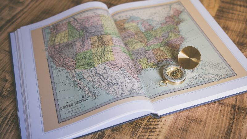 compass on map book page
